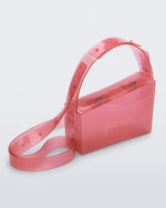Angled view of a clear pink Clear Bag with strap