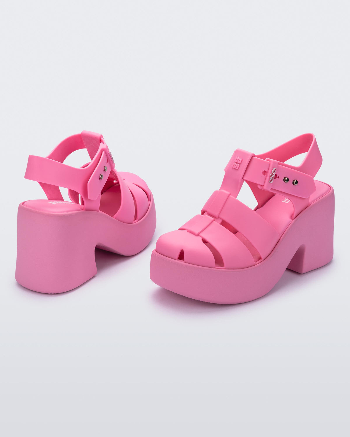 Back and angled view of a pair of matte pink Lulu platform heel sandals
