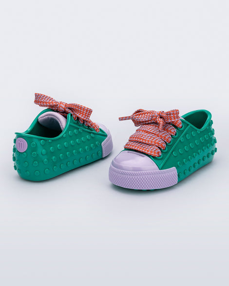 Back and angled view of a pair of green and purple Polibolha baby sneakers with multicolor laces.