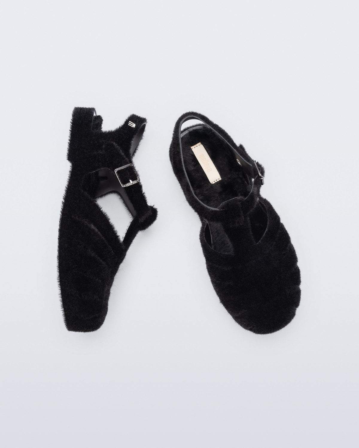 Top and side view of a pair of black fuzzy Possession Warm fisherman sandals