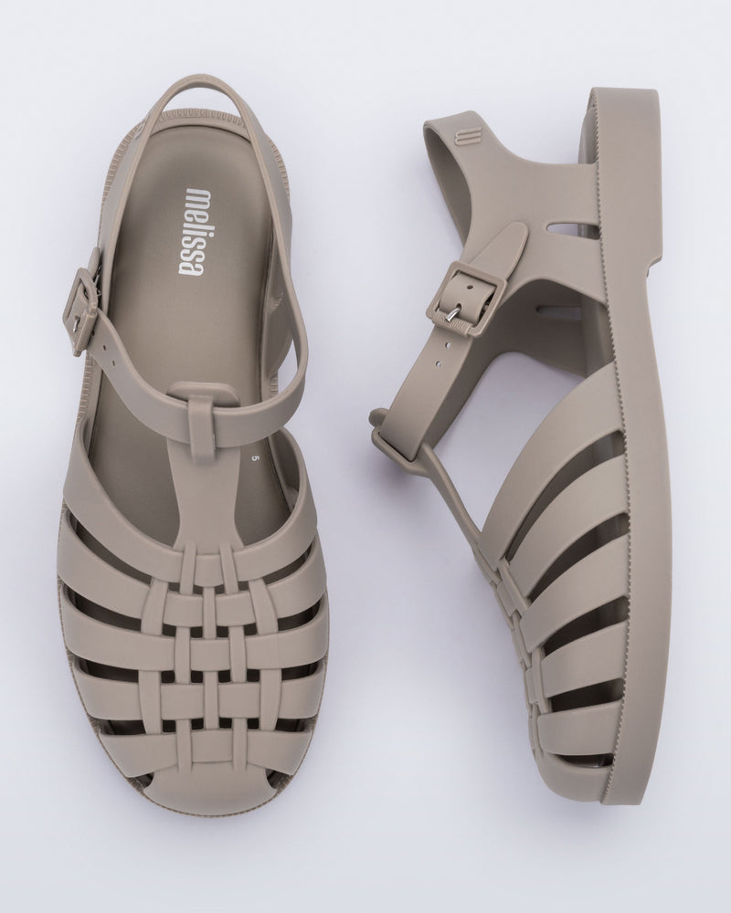 Top and side view of a pair of matte beige Possession adult fisherman style sandal
