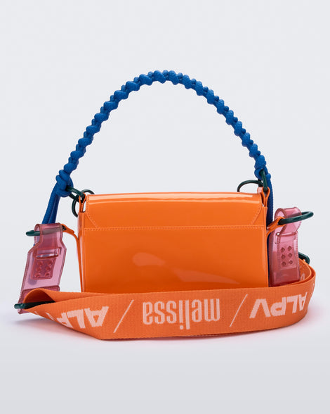 Back view of an orange Olga Bag + Alexandre Pavao with blue short strap fabric long  strap