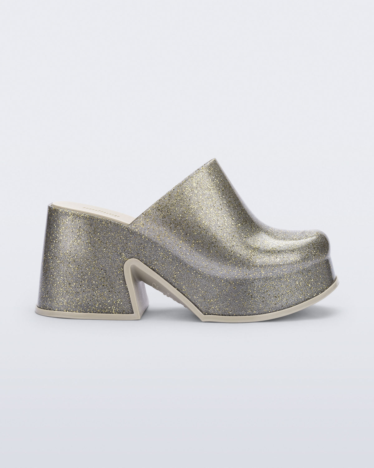 Side view of a golden glitter silver Mia mule with white sole