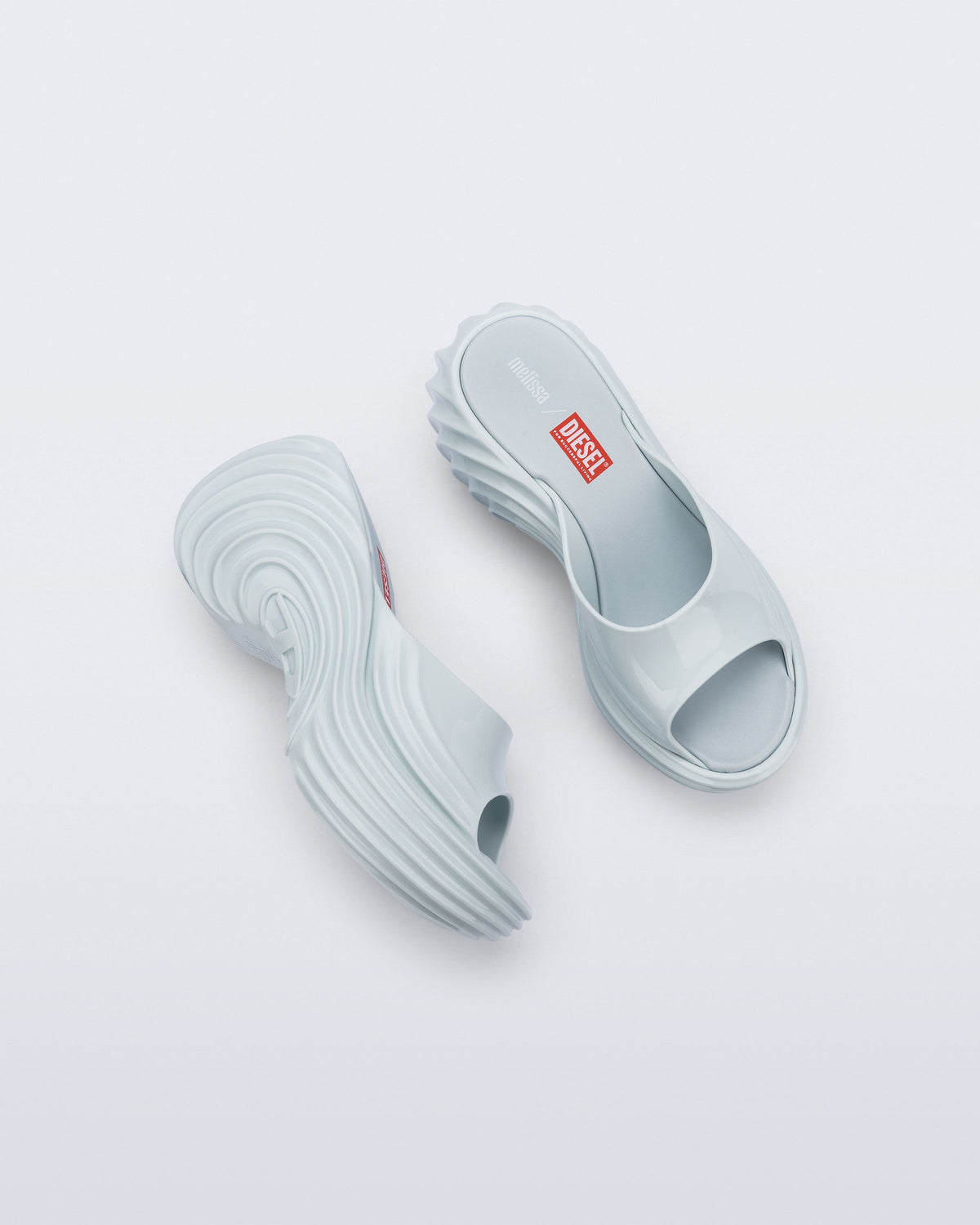 Top and side view of a pair of light blue Platforms + Diesel slides