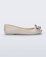 Side view of a beige Sweet Love Glam ballerina flat with chrome bow