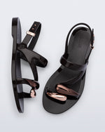 Top and side view of a pair of black Iris sandals with copper upper embellishments