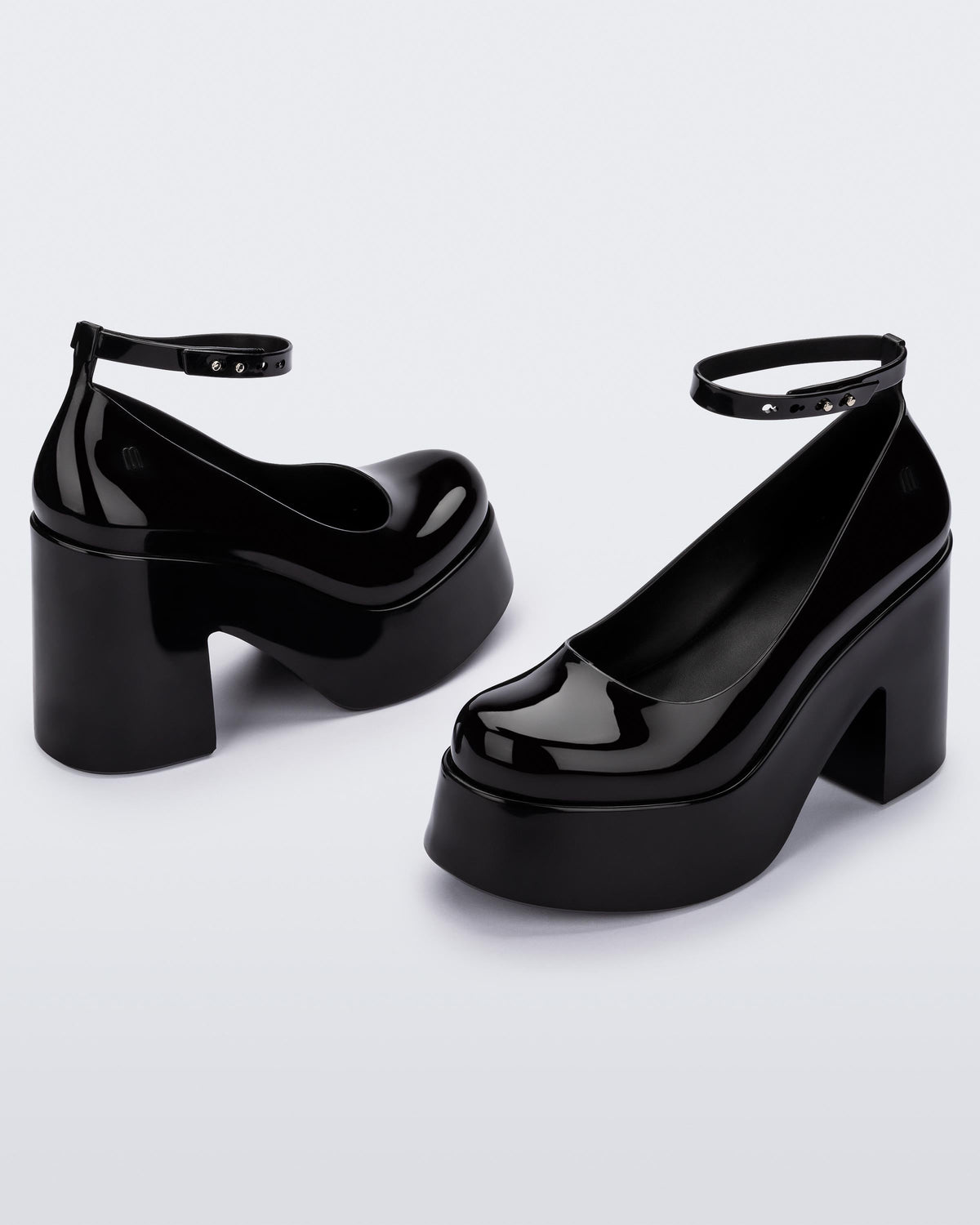 Angled view of a pair of black Melissa Doll Heel platforms with ankle strap.