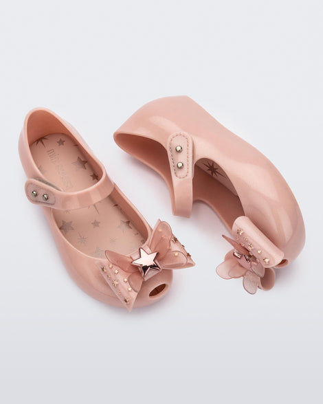 Top and side view of a pair of Mini Melissa Ultragirl peeptoe ballet flats for baby in pink with star printed butterfly bow applique.