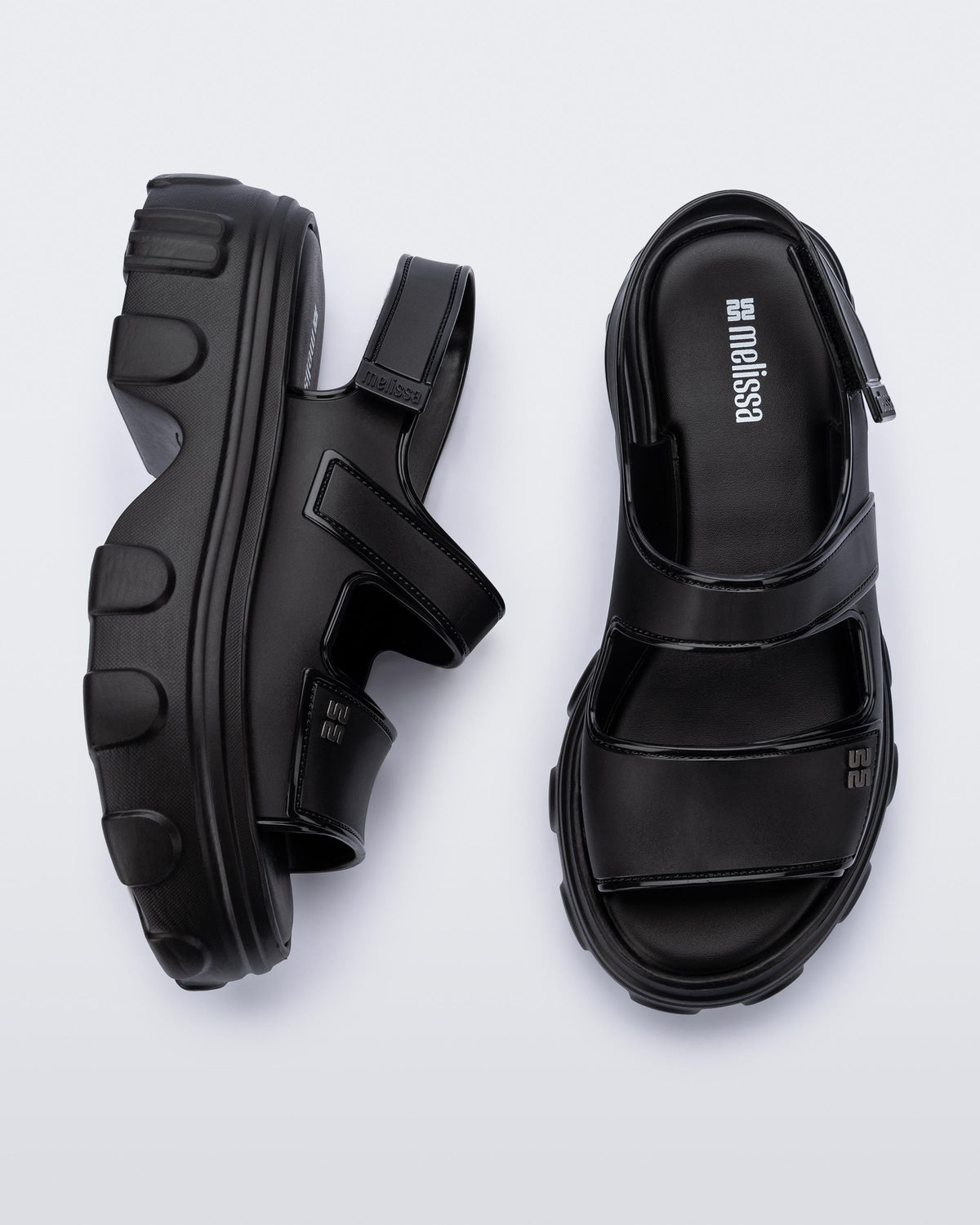 Top and side view of a pair of black Ella Move platform sandals.