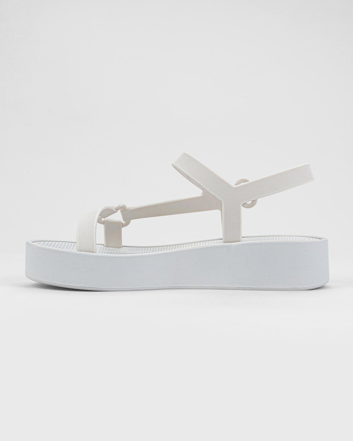 Inner side view of a pair of white Sun Downtown Platform sandals