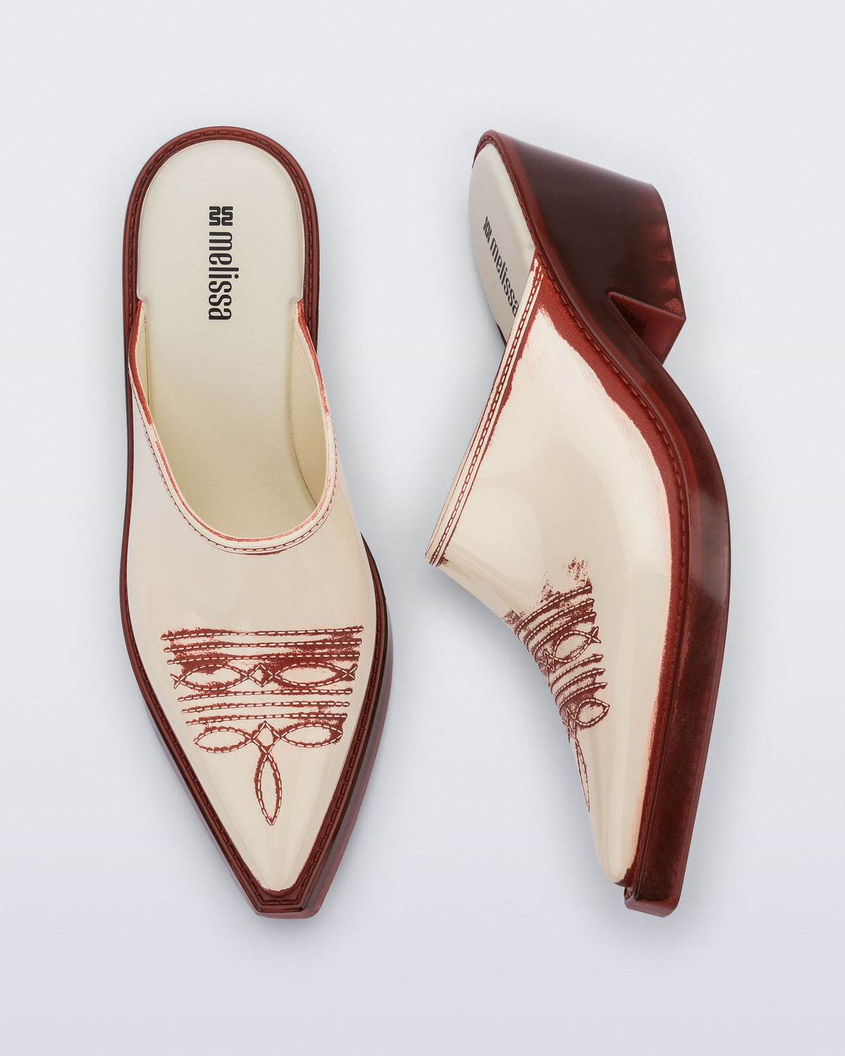Side and top view of a pair of beige with red heel and accents Texas Mule heels