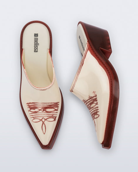 Side and top view of a pair of beige with red heel and accents Texas Mule heels