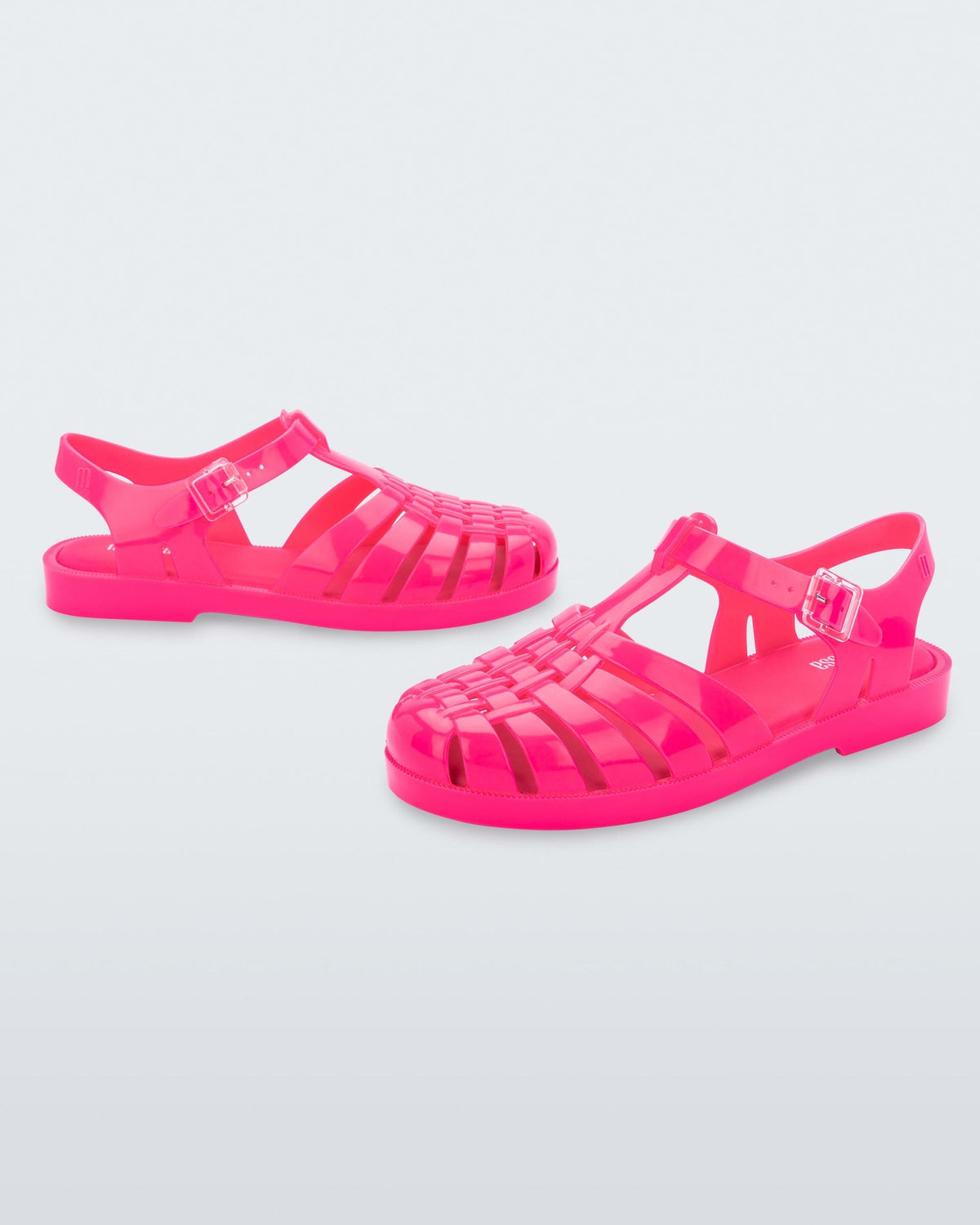 Side angled view of a pair of pink Possession fisherman style sandals.