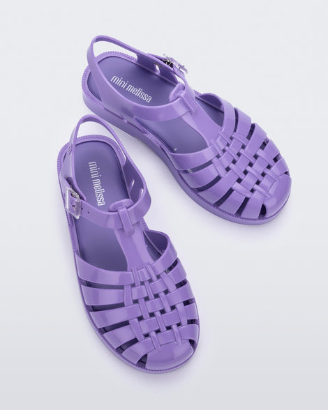 Top view of a pair of lilac Mini Melissa Possession sandals with several straps and a lilac base.