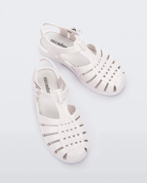 Top view of a pair of white Mini Melissa Possession sandals with several straps and a white base.
