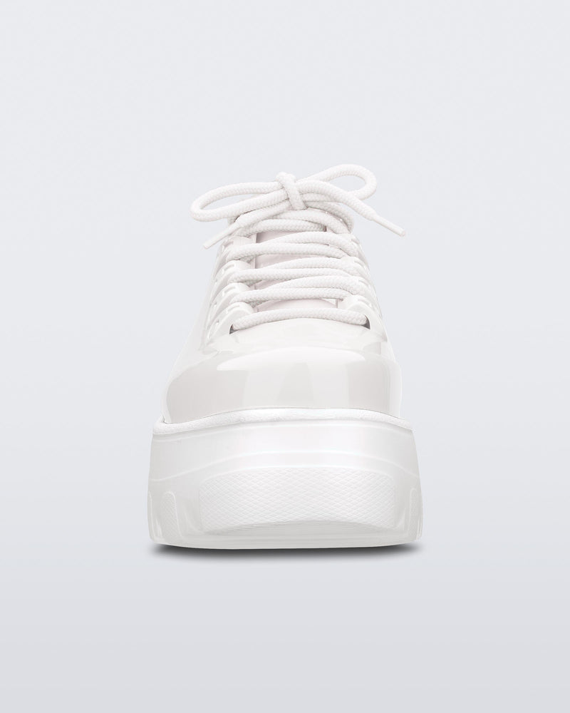 Front view of Melissa Kick Off platform sneaker in white. The sneaker has traditional white tie up laces.