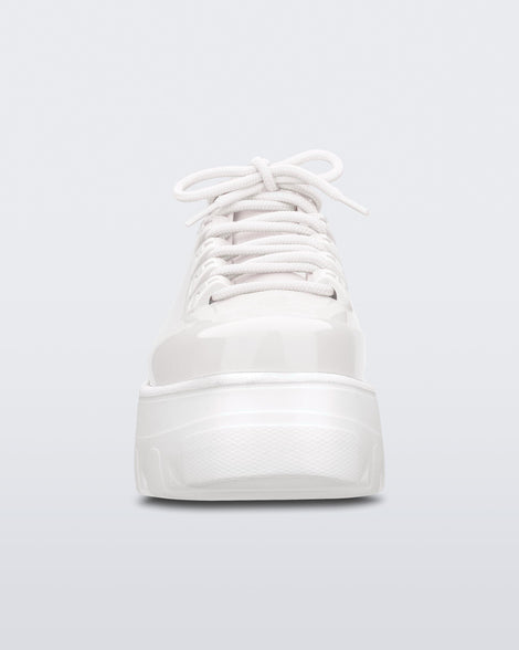 Front view of Melissa Kick Off platform sneaker in white. The sneaker has traditional white tie up laces.