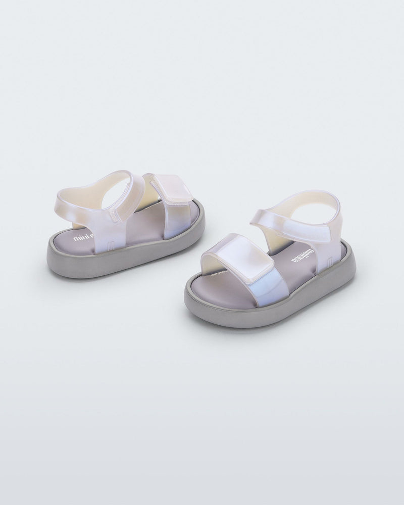 Angled view of a pair of pearly blue Mini Melissa Jump baby sandal.