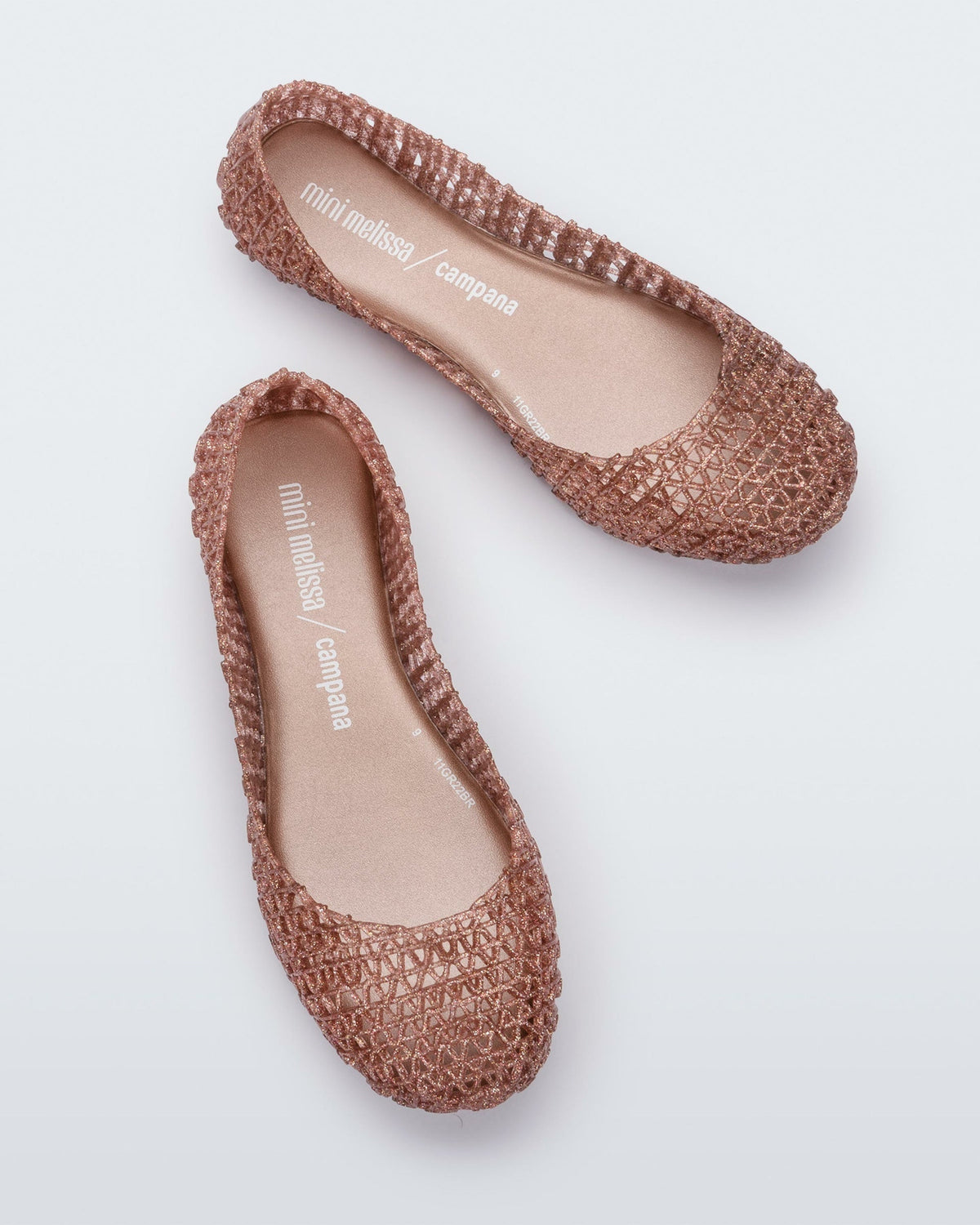 Top view of a pair of rose glitter Mini Melissa Campana flats with a woven detail base.