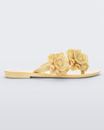 Side view of a yellow Melissa Harmonic Garden flip flop with flowers on the straps.