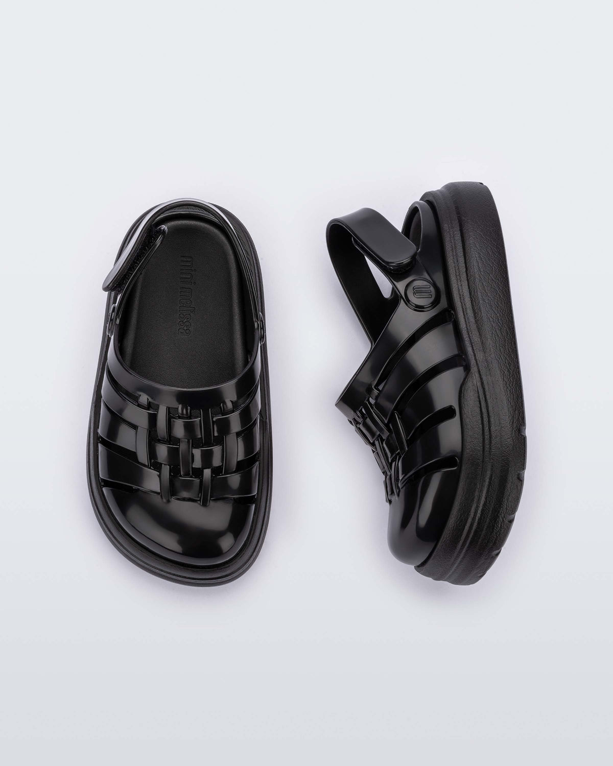 A top and side view of a pair of black Mini Melissa Sunday sandals with woven closed toe front and back ankle strap.