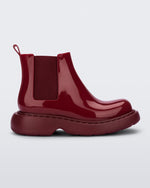 Side view of a Melissa Step slip on ankle boot in Red with stretch side detail and lugg sole