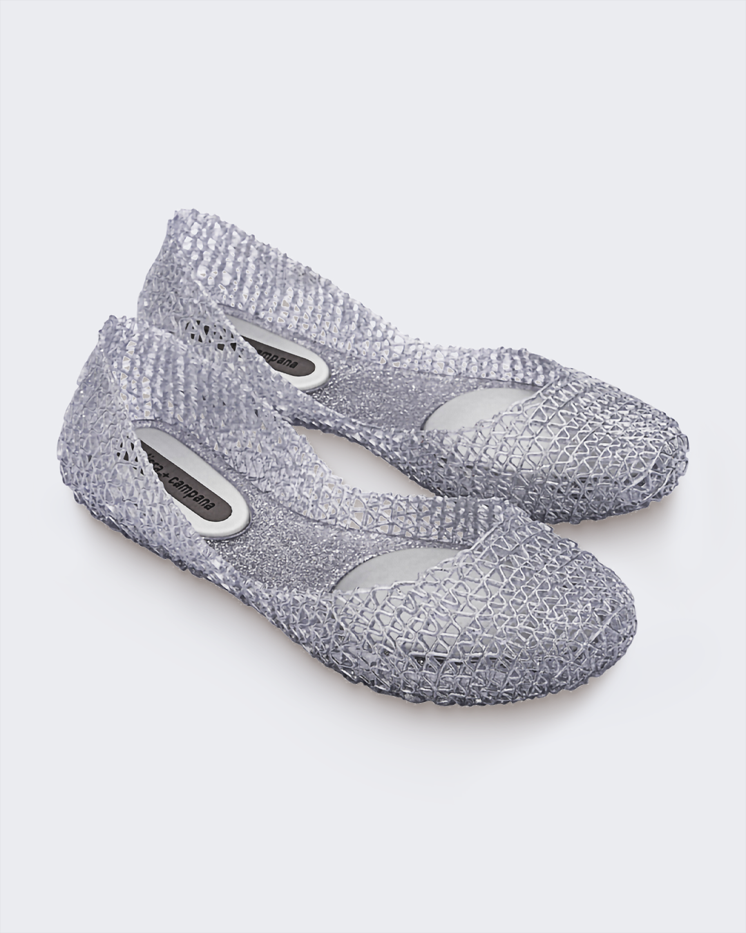 Angled view of a pair of Melissa Campana flats in clear