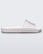 Side view of a clear/white Melissa Court Slide with a checkered pattern texture.