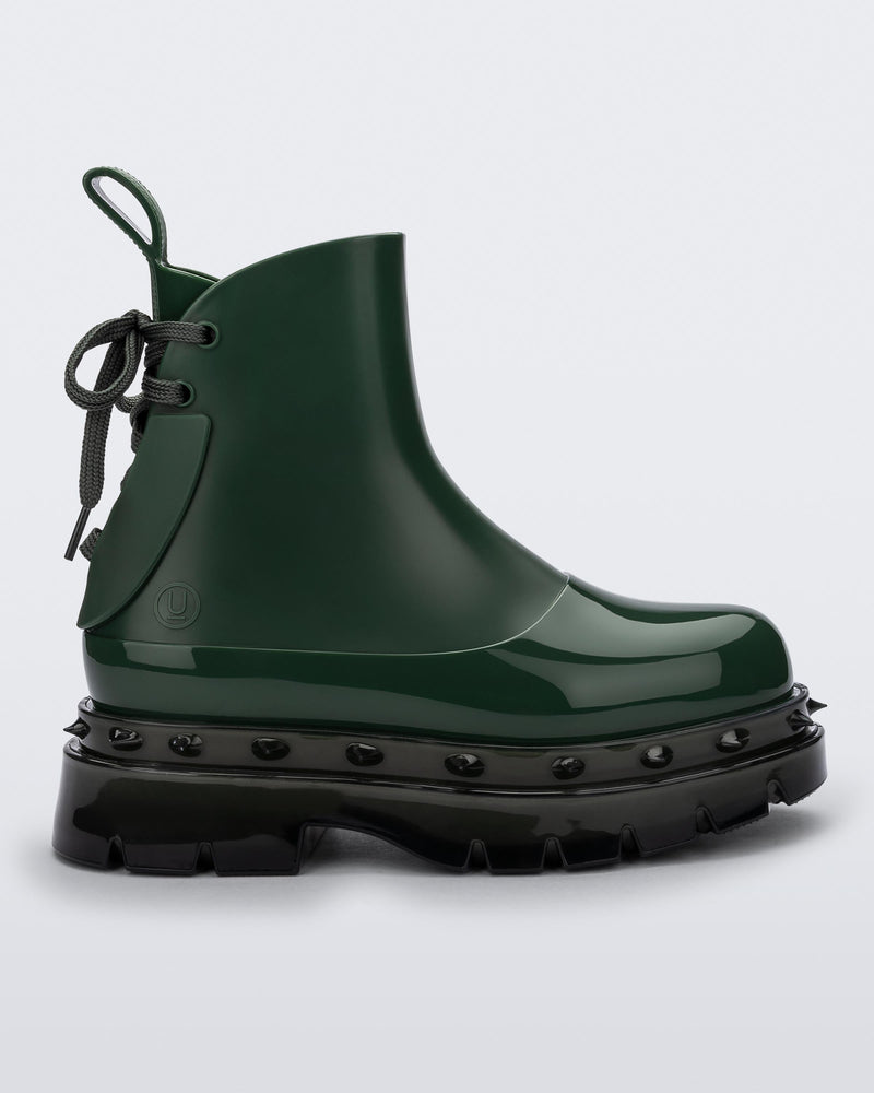 Side view of a green Melissa Spikes Boot with spike details around the sole and laces in the back.