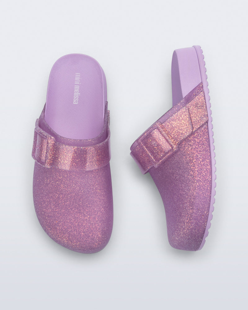 Side and top view of a pair of glitter lilac Cozy Clog for kids