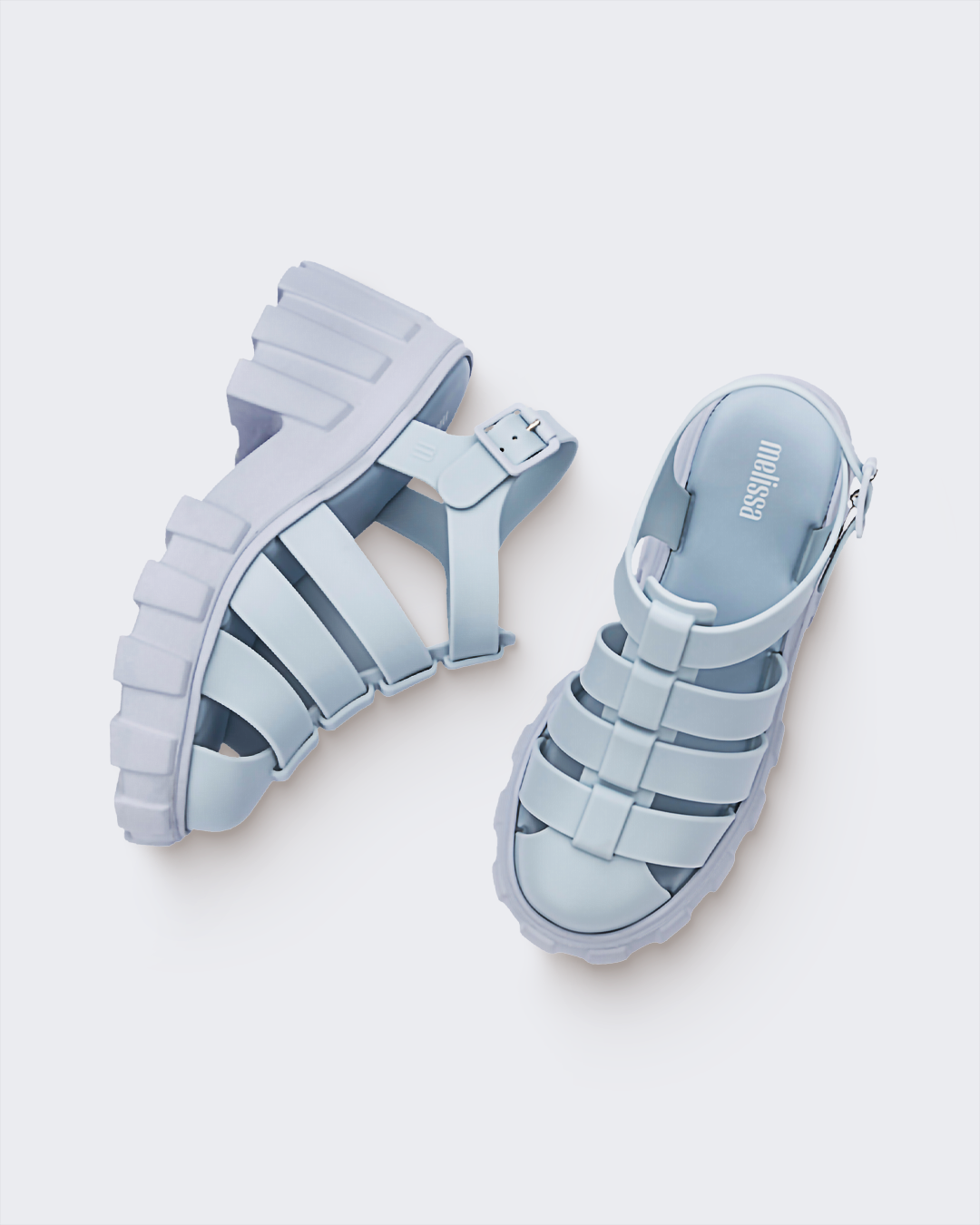Top and side view of a pair of Melissa Megan platform sandals in light blue