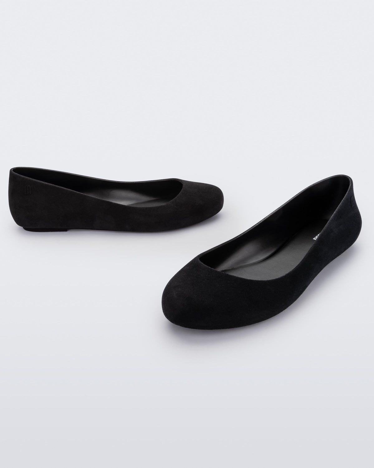 Angled view of a pair of black flocked Melissa Sweet Love Basic Velvet flats.