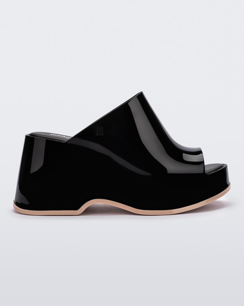 Side view of a Black Melissa Patty platform mule with beige outsole.