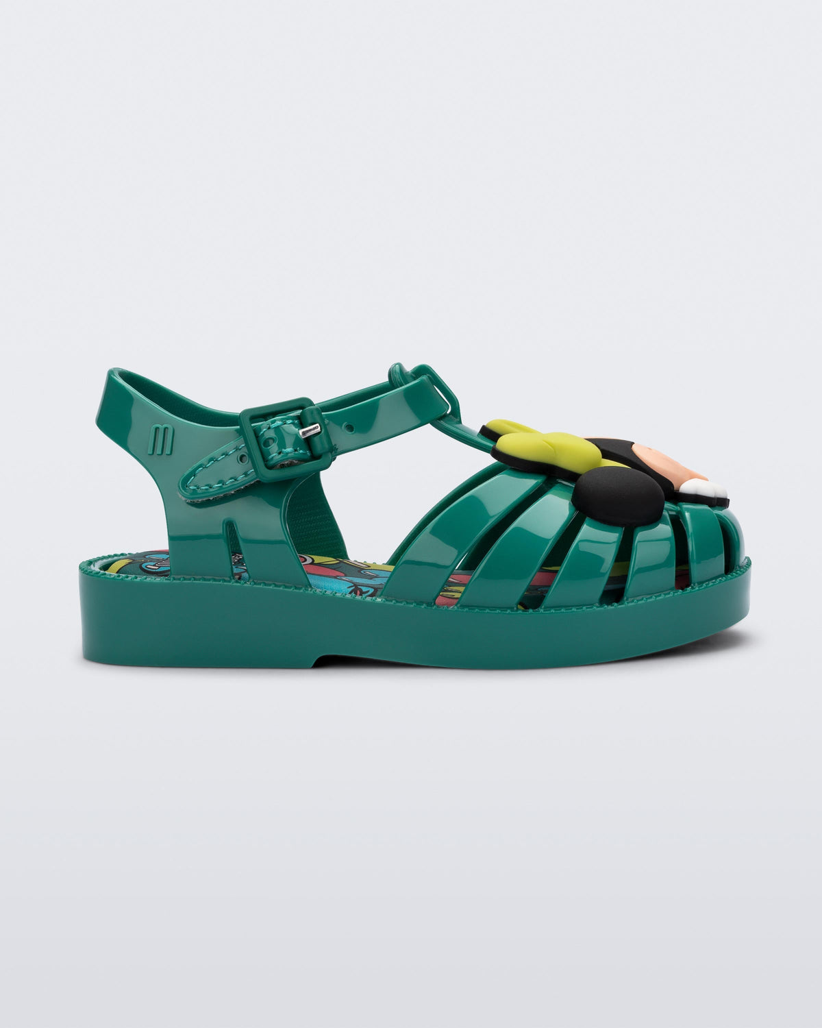 Side view of a green Mini Melissa Possession + Disney 100 sandal with Mickey on one foot and Minnie on another foot.