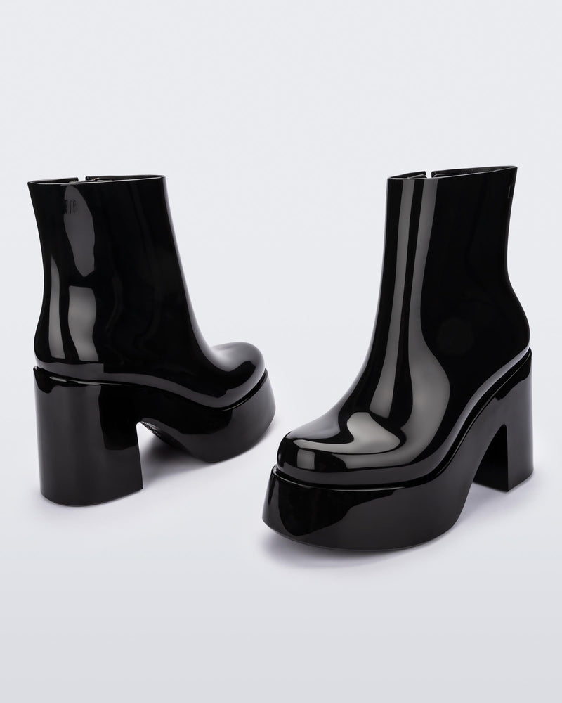 Angled and back view of a pair of black Melissa Nubia platform heel boots.