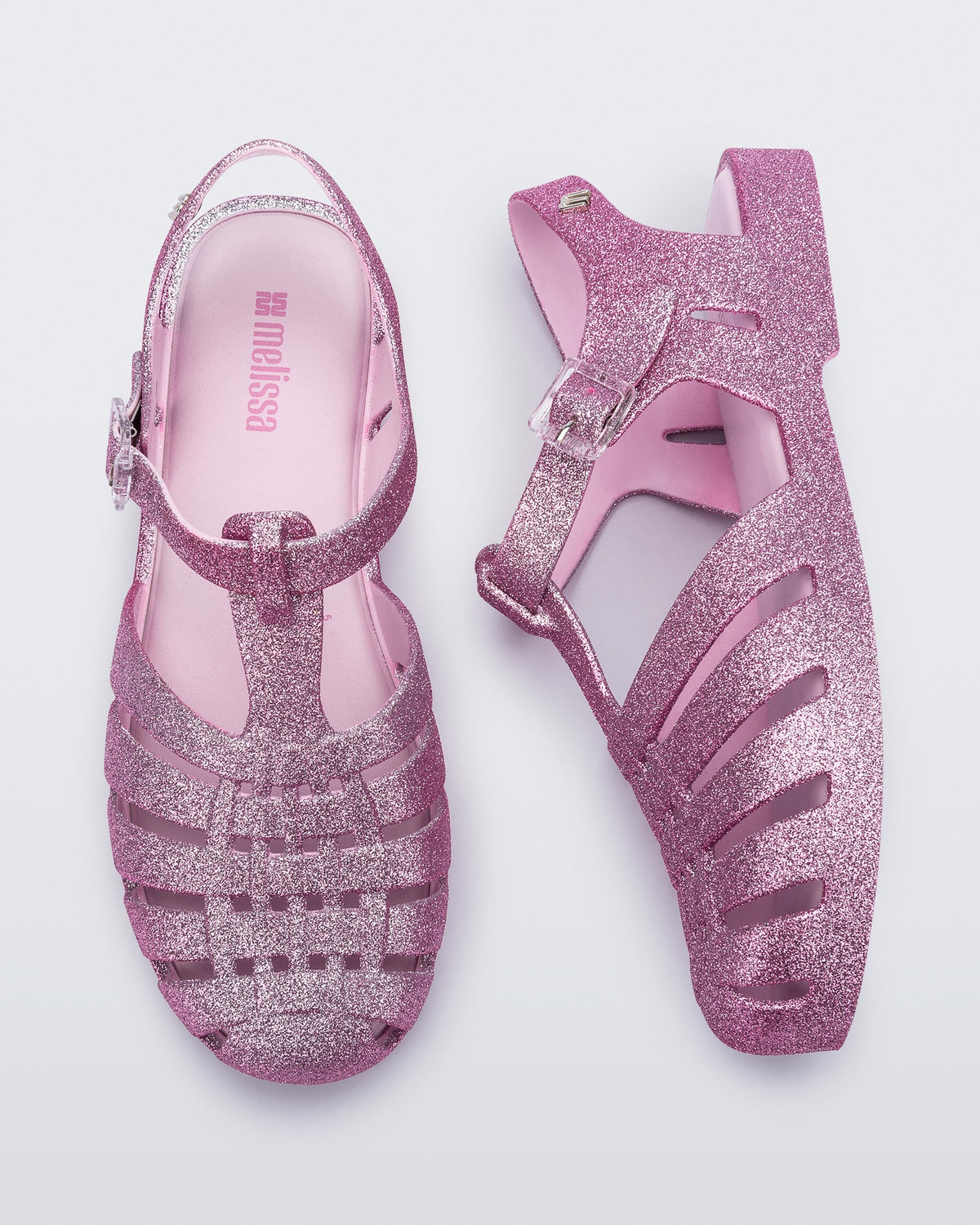 Top and side view of a pair of glitter pink Possession sandals.