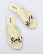 Top view of a pair of Harmonic Eclipse flip flops with bow.