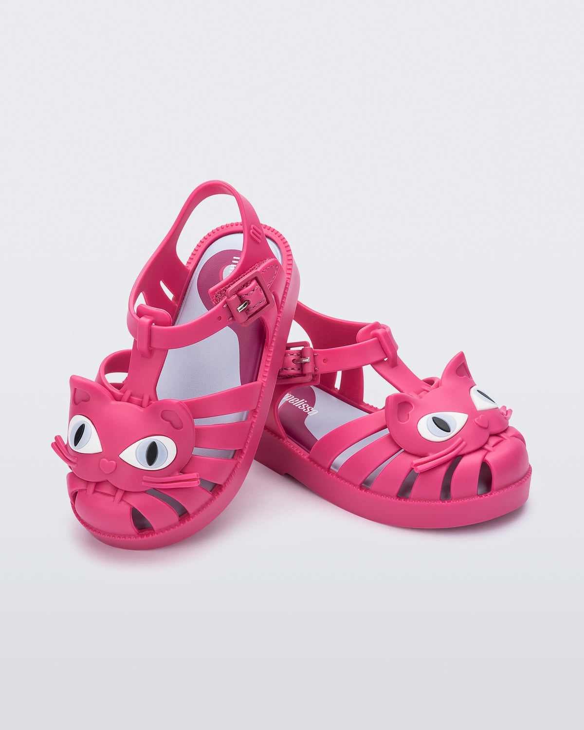 Angled view of a pair of pink baby Possession Cat sandals