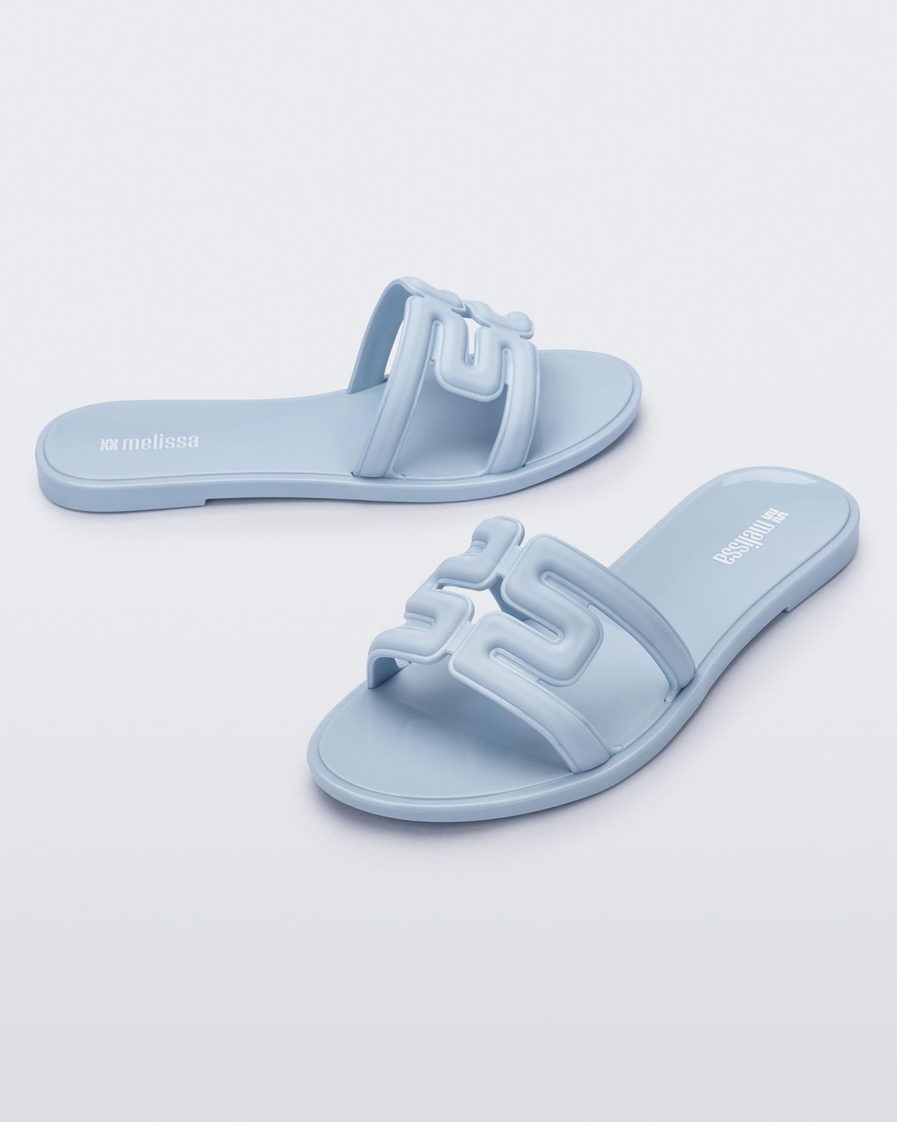 Angled view of a pair of light blue M Slides.