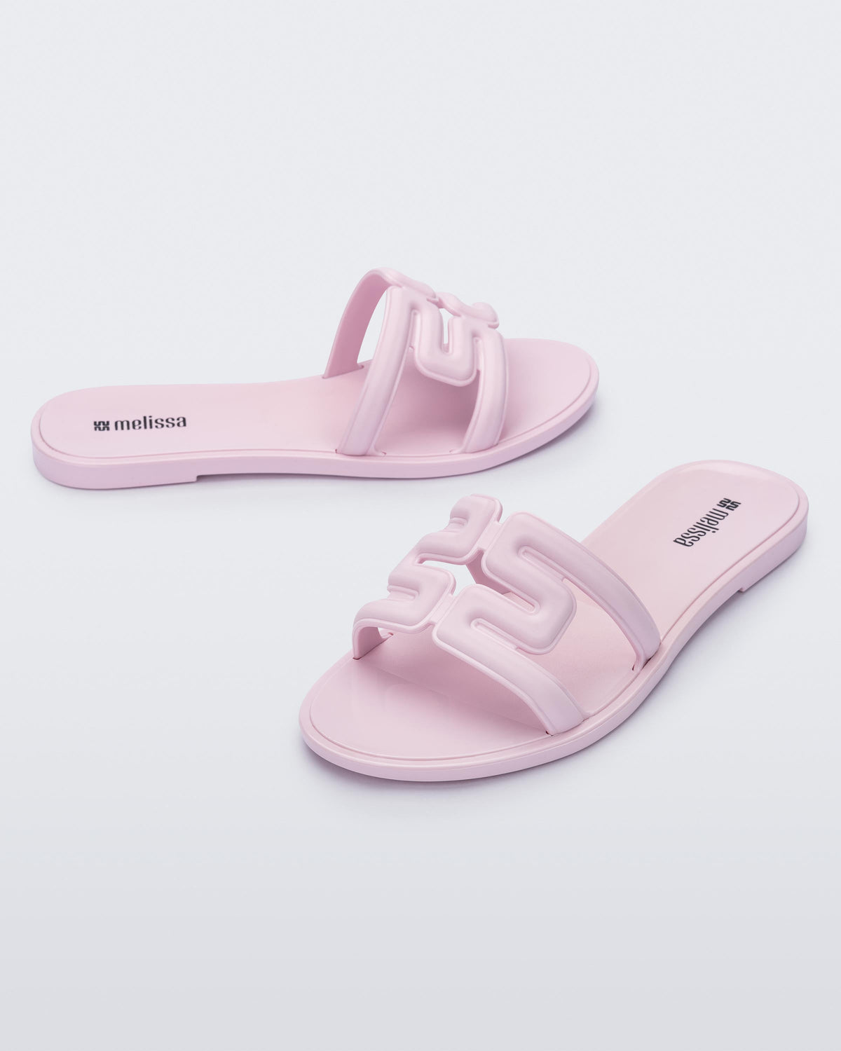 Angled view of a pair of light pink M Slides.