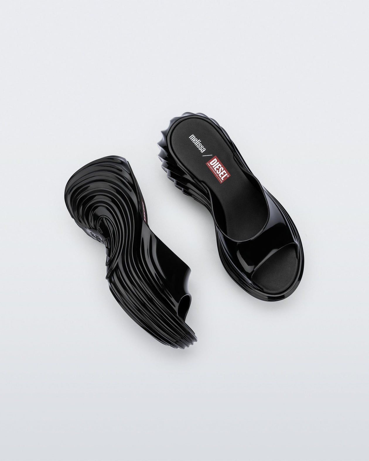 Top and side view of a pair of black Platforms + Diesel slides