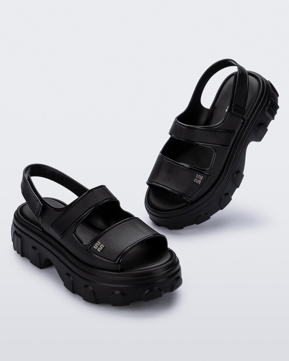 Angled view of a pair of black Ella Move platform sandals.