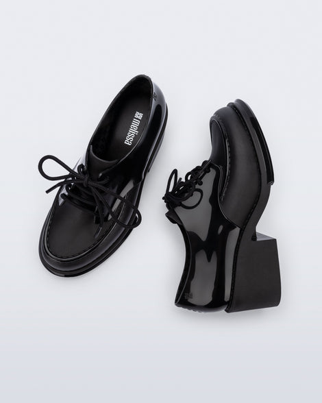 Side and top view of a pair of black Tailor loafers