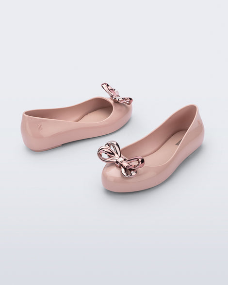 Angled and side view of a pair of pink Sweet Love Glam kids ballerina flats with bow