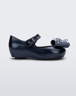 Side view of a Mini Melissa Ultragirl peeptoe ballet flat for baby in blue with star printed butterfly bow applique.