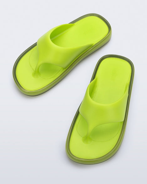 Top view of a pair of green Float flip flops