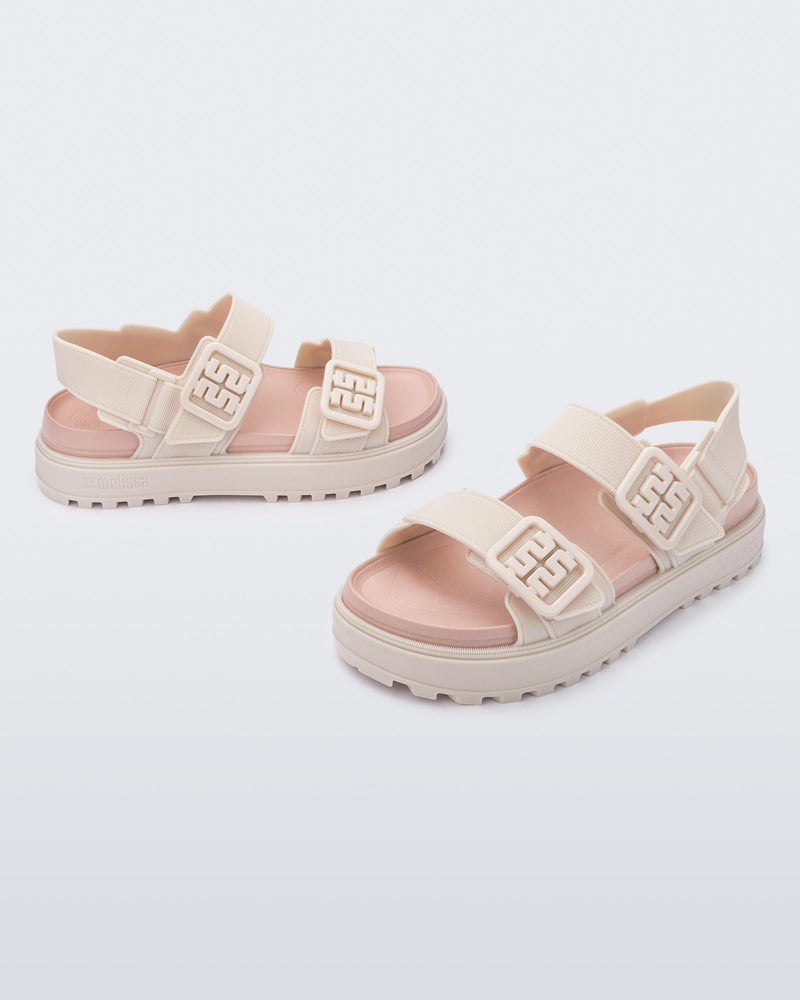 Side and front angled view of a pair of pink Towny sandals with straps