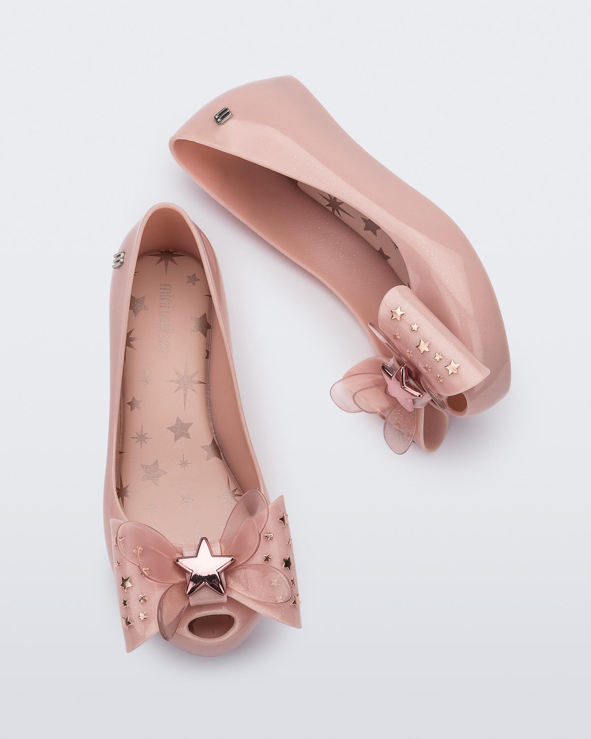 Top and side view of a pair of Mini Melissa Ultragirl peeptoe ballet flats in pink with star printed butterfly bow applique.