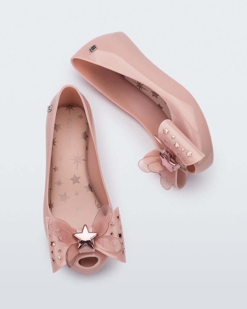 Top and side view of a pair of Mini Melissa Ultragirl peeptoe ballet flats in pink with star printed butterfly bow applique.