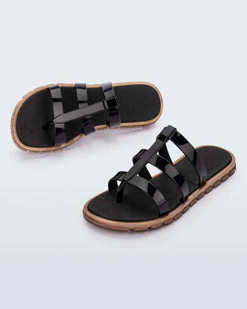 Top and angled view of a pair of black Path adult sandals with gold sole
